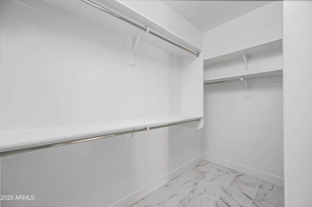 spacious closet with marble finish floor