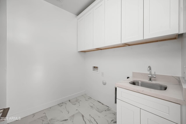 laundry room featuring marble finish floor, hookup for a washing machine, cabinet space, a sink, and baseboards