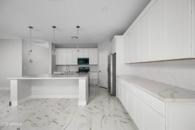 kitchen with marble finish floor, stainless steel appliances, white cabinetry, a sink, and baseboards