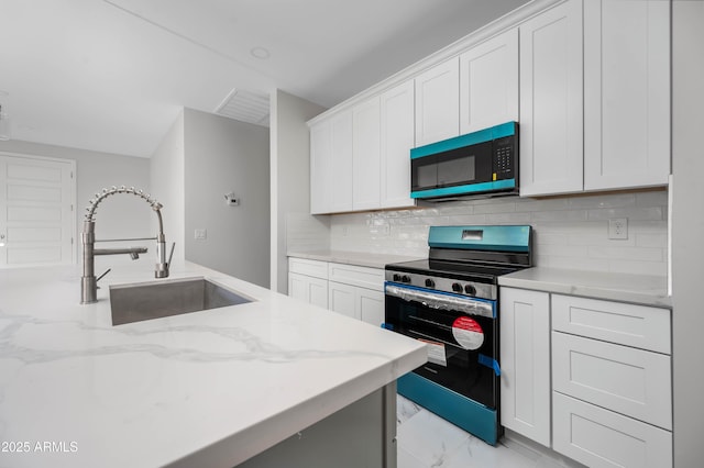 kitchen featuring electric stove, tasteful backsplash, white cabinetry, a sink, and light stone countertops