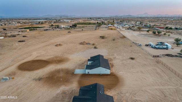 drone / aerial view featuring a desert view and a mountain view