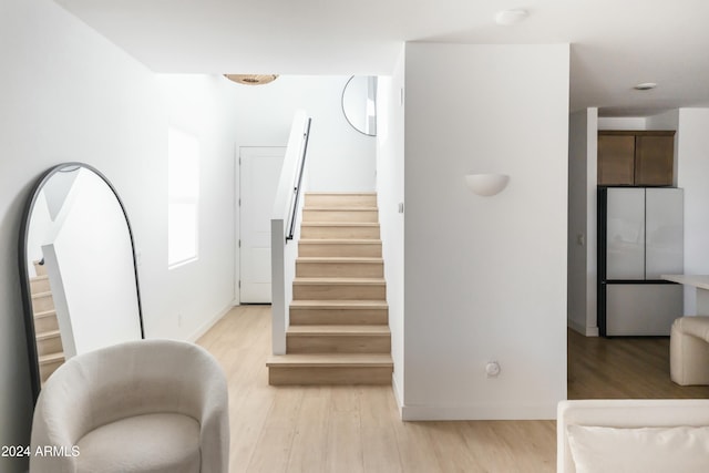 stairs featuring hardwood / wood-style floors