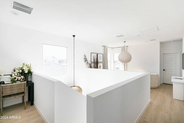 corridor with light hardwood / wood-style flooring