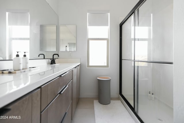 bathroom with vanity, an enclosed shower, and tile patterned flooring