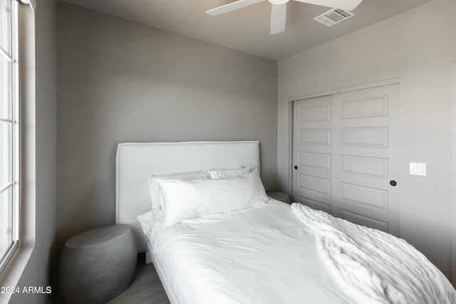 bedroom with ceiling fan and a closet