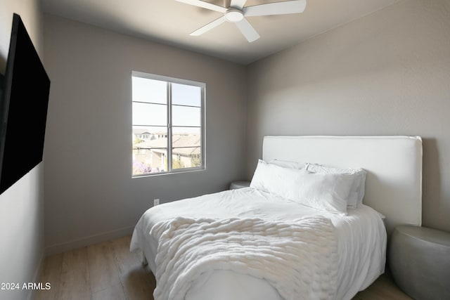 bedroom with ceiling fan and wood-type flooring