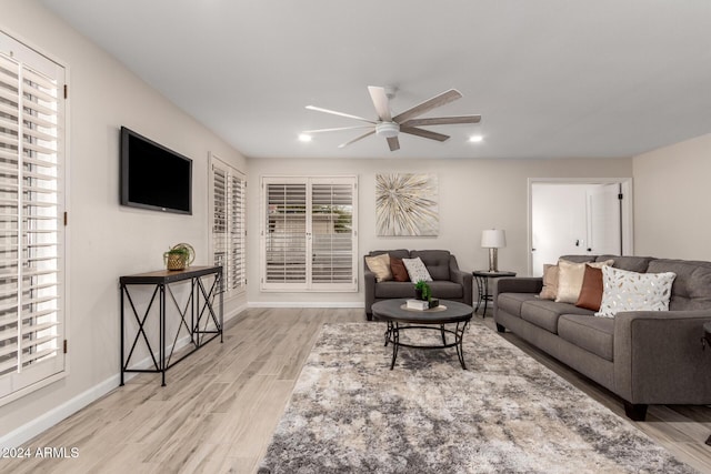 living room featuring light wood-type flooring and ceiling fan