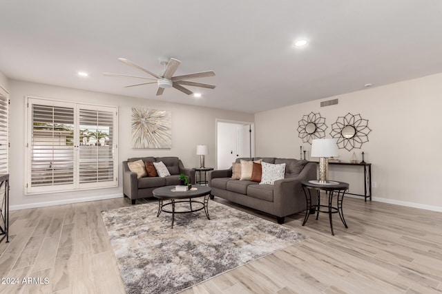 living room featuring ceiling fan and light wood-type flooring