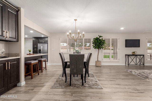 dining space featuring a chandelier and light hardwood / wood-style floors