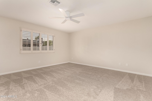 carpeted spare room featuring ceiling fan