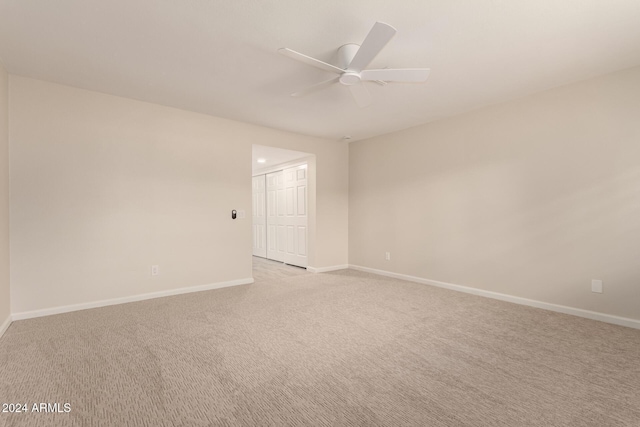 empty room with light carpet and ceiling fan