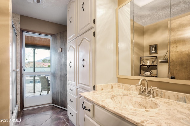 bathroom with a textured ceiling and vanity