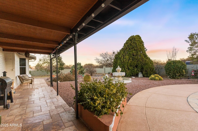 view of patio terrace at dusk