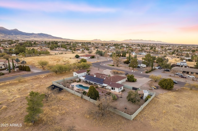 aerial view at dusk featuring a mountain view