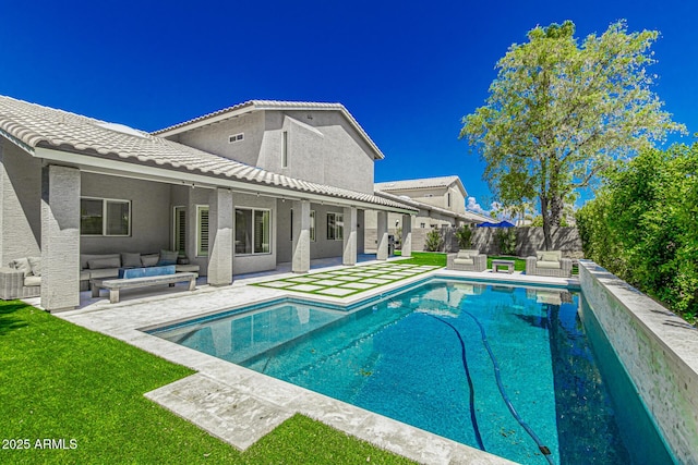 view of pool featuring outdoor lounge area, a lawn, and a patio