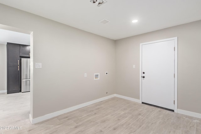 clothes washing area with electric dryer hookup, washer hookup, and light wood-type flooring