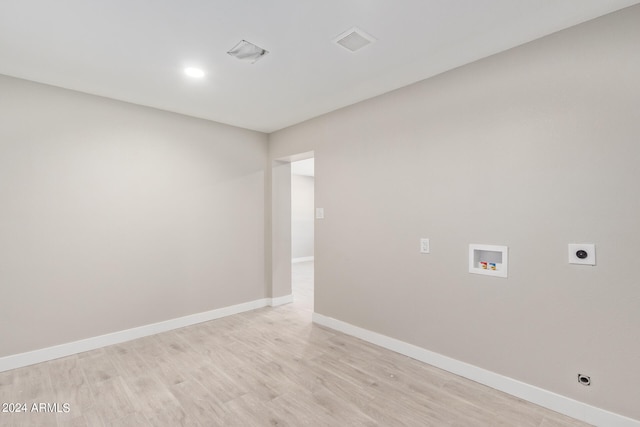 washroom with light wood-type flooring, hookup for a washing machine, and electric dryer hookup