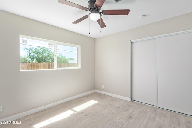 unfurnished bedroom with ceiling fan, light hardwood / wood-style floors, and a closet