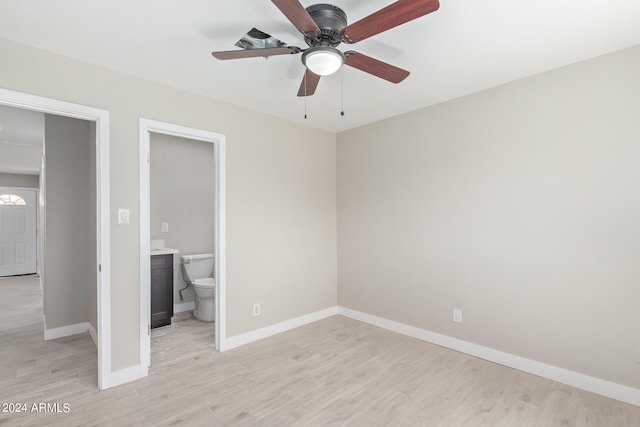 unfurnished bedroom featuring ensuite bathroom, ceiling fan, and light wood-type flooring