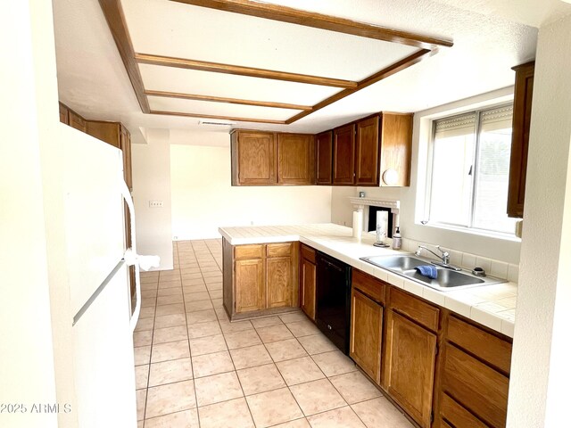 4330 E Beck Ln, Phoenix, AZ 85032 - kitchen featuring light tile patterned flooring, a sink, freestanding refrigerator, black dishwasher, and tile countertops