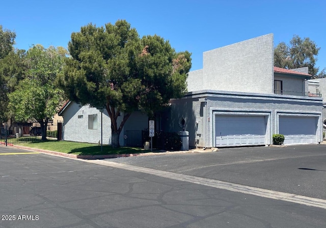 view of front of house with a garage and stucco siding