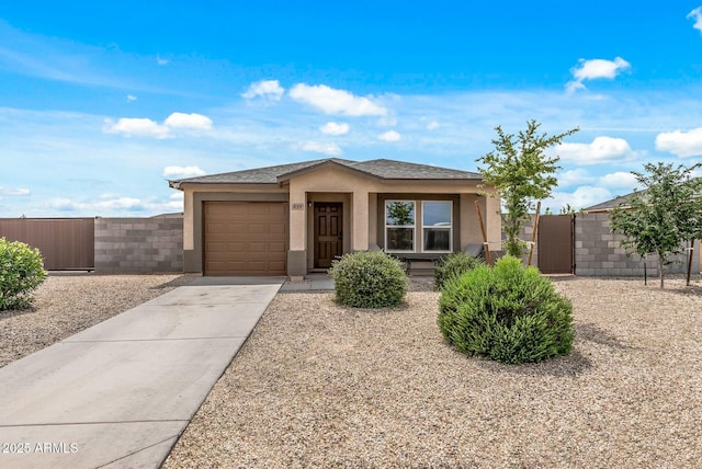 459 Brandeis Dr, Morristown, AZ 85342 - view of front of house featuring a gate, driveway, an attached garage, fence, and stucco siding