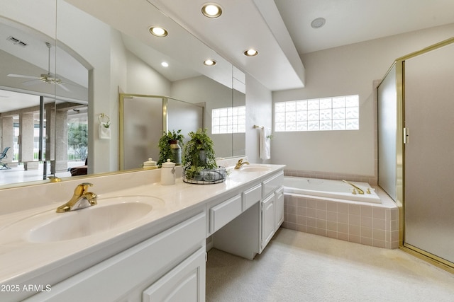 bathroom with vanity, ceiling fan, and plus walk in shower