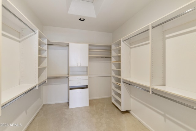 walk in closet featuring light carpet