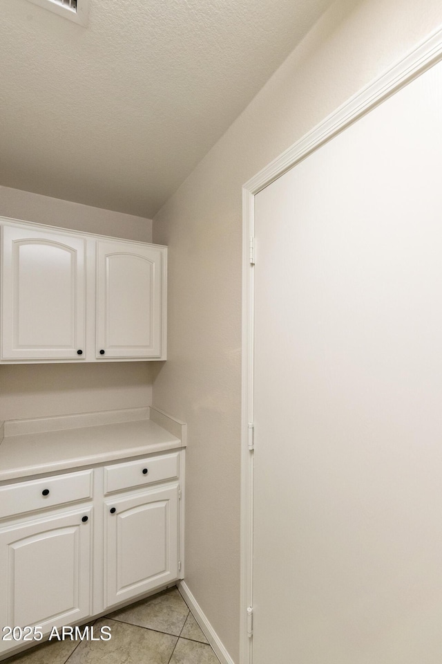 laundry room with light tile patterned floors