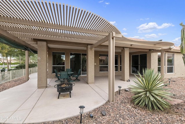 view of patio / terrace with a fire pit and a pergola