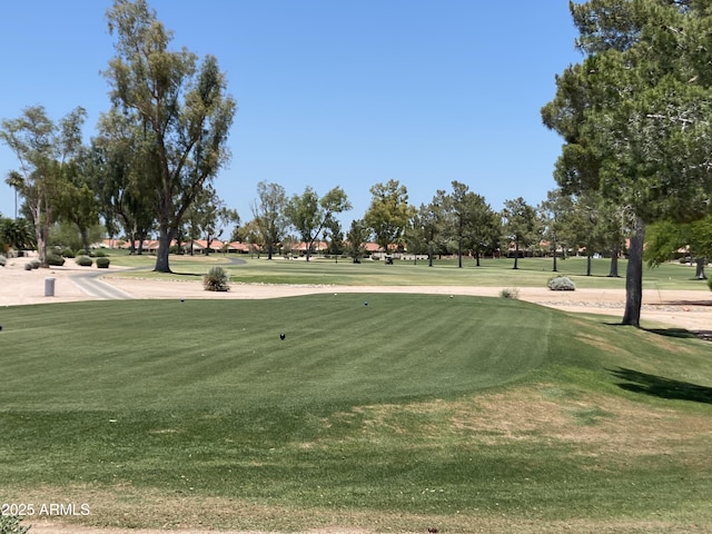 view of property's community with a lawn