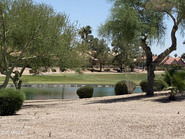 view of community featuring a lawn and a water view