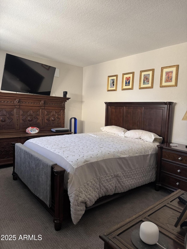 carpeted bedroom featuring a textured ceiling