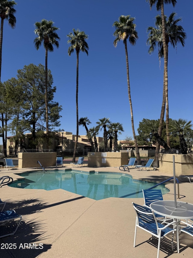 pool featuring a patio and fence