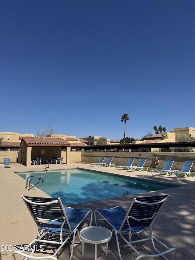 pool featuring a patio and fence