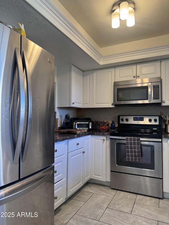 kitchen with appliances with stainless steel finishes and white cabinets