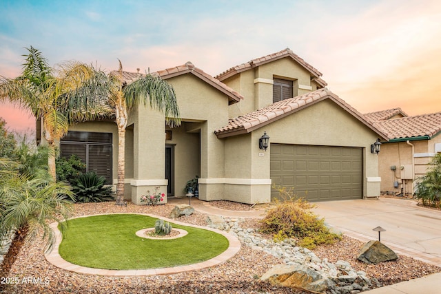 mediterranean / spanish-style house featuring a garage, a tiled roof, concrete driveway, and stucco siding