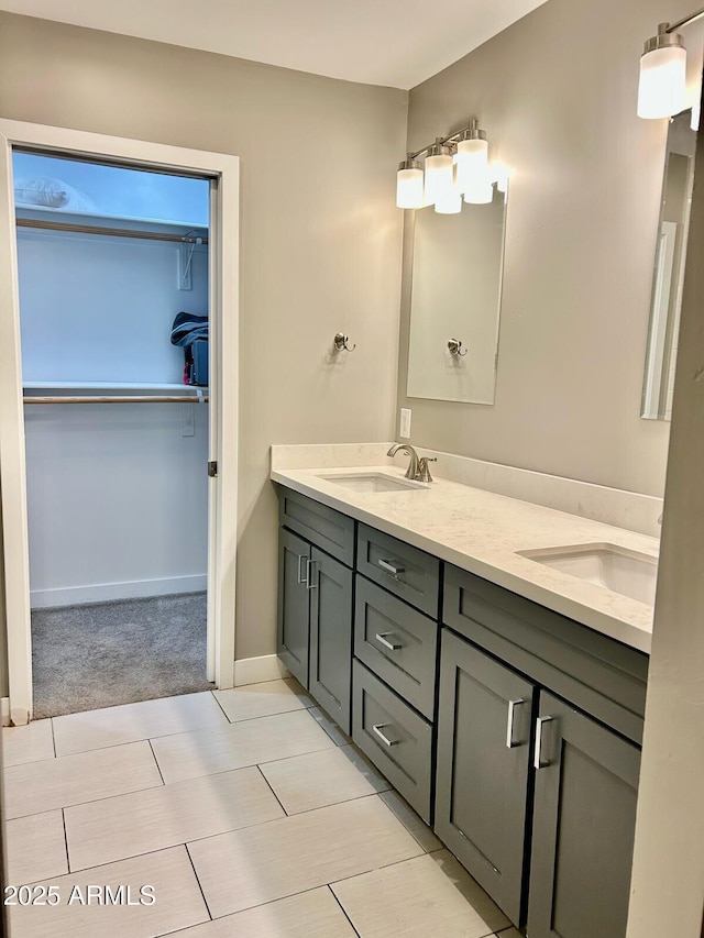 7635 E Verde Ln, Scottsdale, AZ 85251 - full bathroom featuring double vanity, a sink, baseboards, and a spacious closet