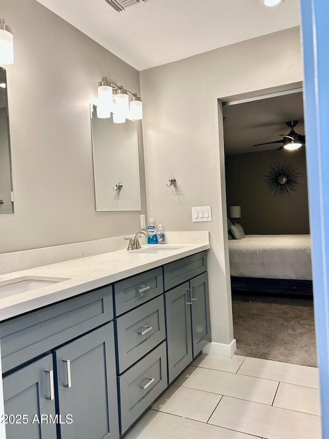 7635 E Verde Ln, Scottsdale, AZ 85251 - bathroom with connected bathroom, a sink, double vanity, ceiling fan, and tile patterned flooring