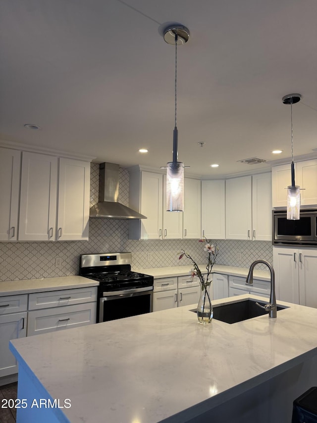 7635 E Verde Ln, Scottsdale, AZ 85251 - kitchen with wall chimney range hood, decorative backsplash, a sink, appliances with stainless steel finishes, and visible vents