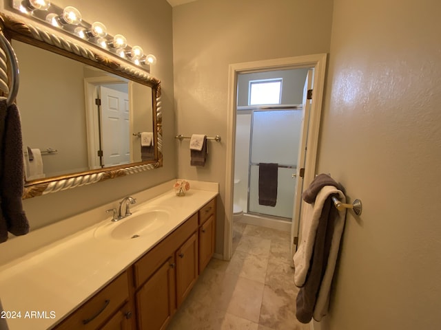 bathroom featuring a shower stall, vanity, and toilet