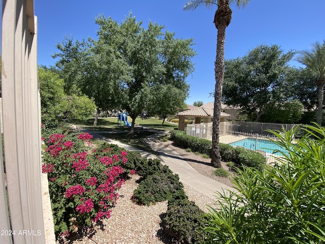 surrounding community with a pool and fence