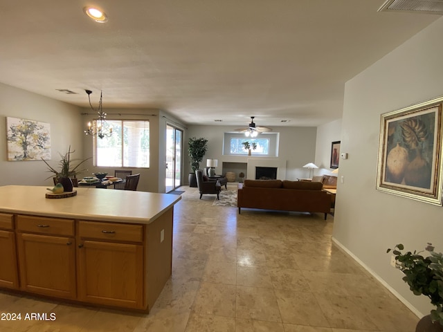 kitchen with a ceiling fan, baseboards, visible vents, light countertops, and pendant lighting