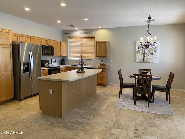 kitchen featuring visible vents, a center island, light countertops, an inviting chandelier, and black appliances