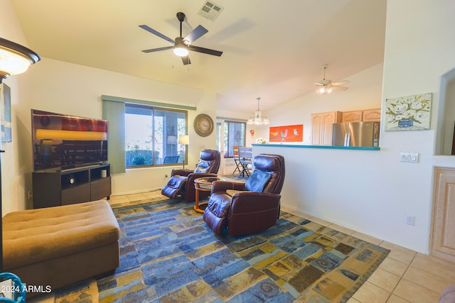 living room with light tile patterned floors, ceiling fan with notable chandelier, and vaulted ceiling