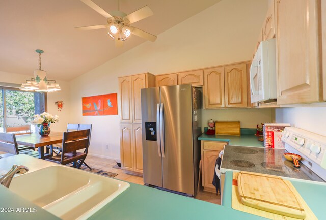 kitchen featuring range, ceiling fan with notable chandelier, vaulted ceiling, stainless steel fridge with ice dispenser, and decorative light fixtures