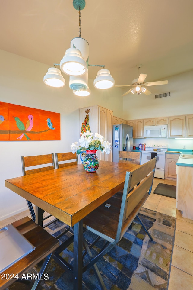 dining space featuring ceiling fan, sink, and light tile patterned floors