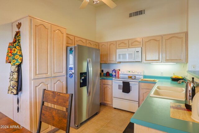 kitchen with ceiling fan, white appliances, light brown cabinetry, sink, and light tile patterned floors