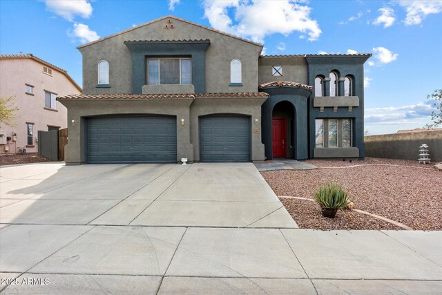 12943 W Mclellan Rd, Glendale, AZ 85307 - mediterranean / spanish house featuring stucco siding, a tiled roof, concrete driveway, and a garage