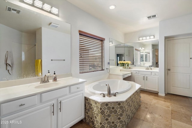 12943 W Mclellan Rd, Glendale, AZ 85307 - full bathroom with visible vents, two vanities, a bath, and a sink